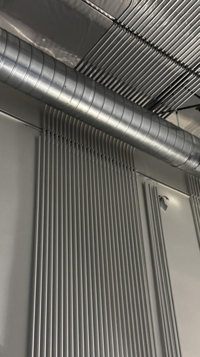 Wall-mounted conduit drops to equipment