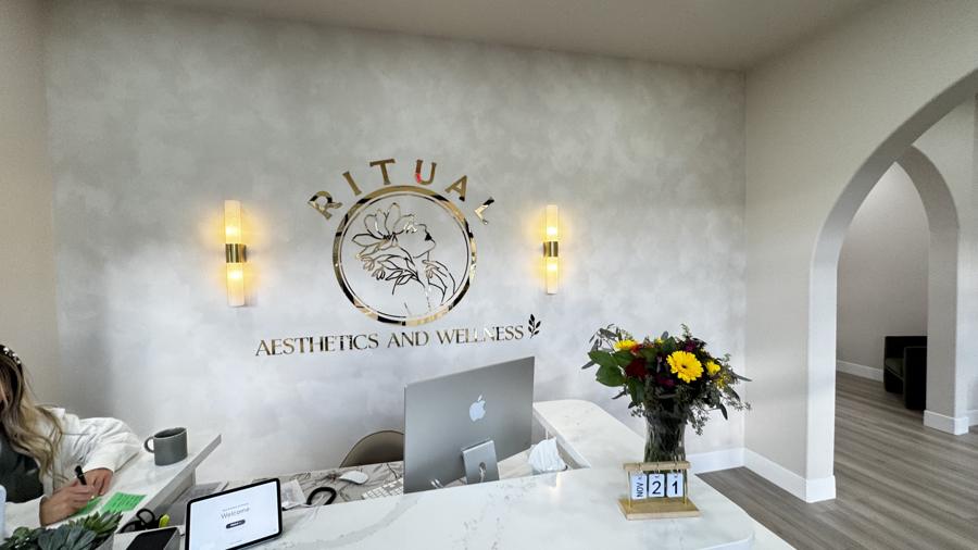 Backlit reception signage and sconces